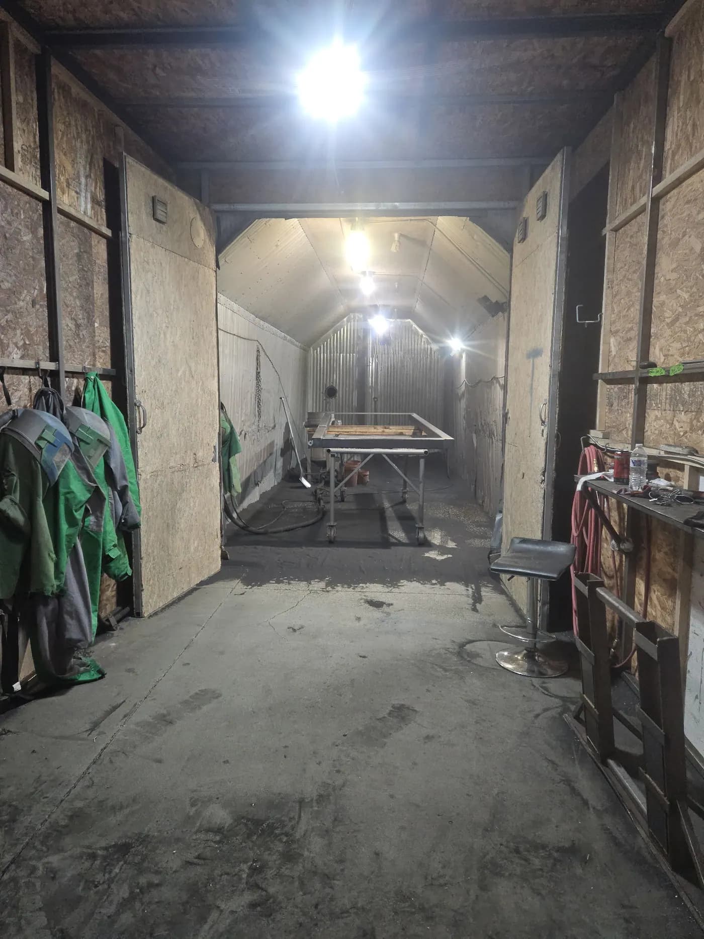 Sandblasting booth used for surface preparation before powder coating.