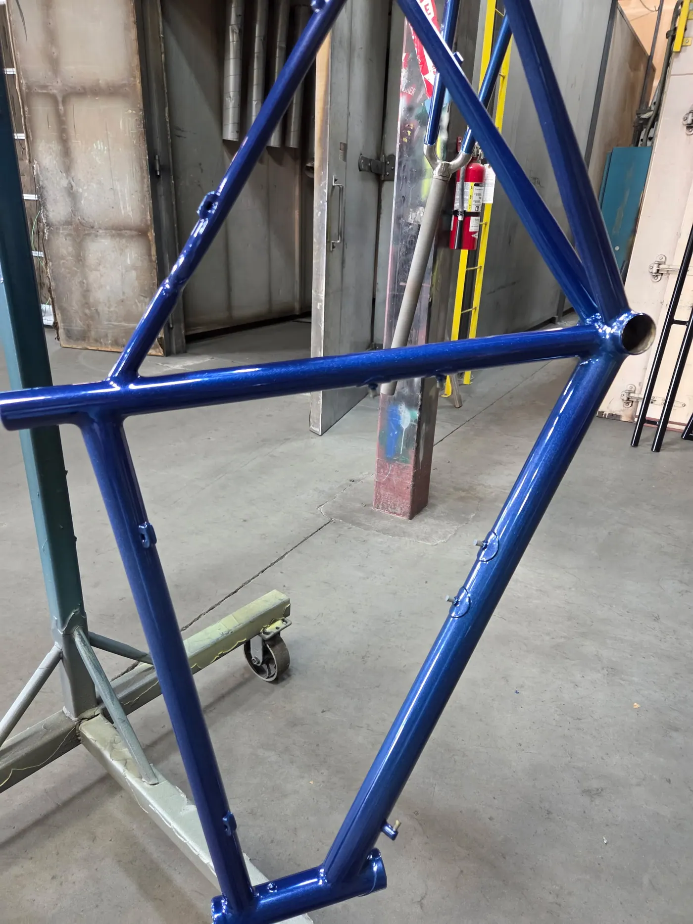 Blue powder coated motorcycle or bicycle frame detail.