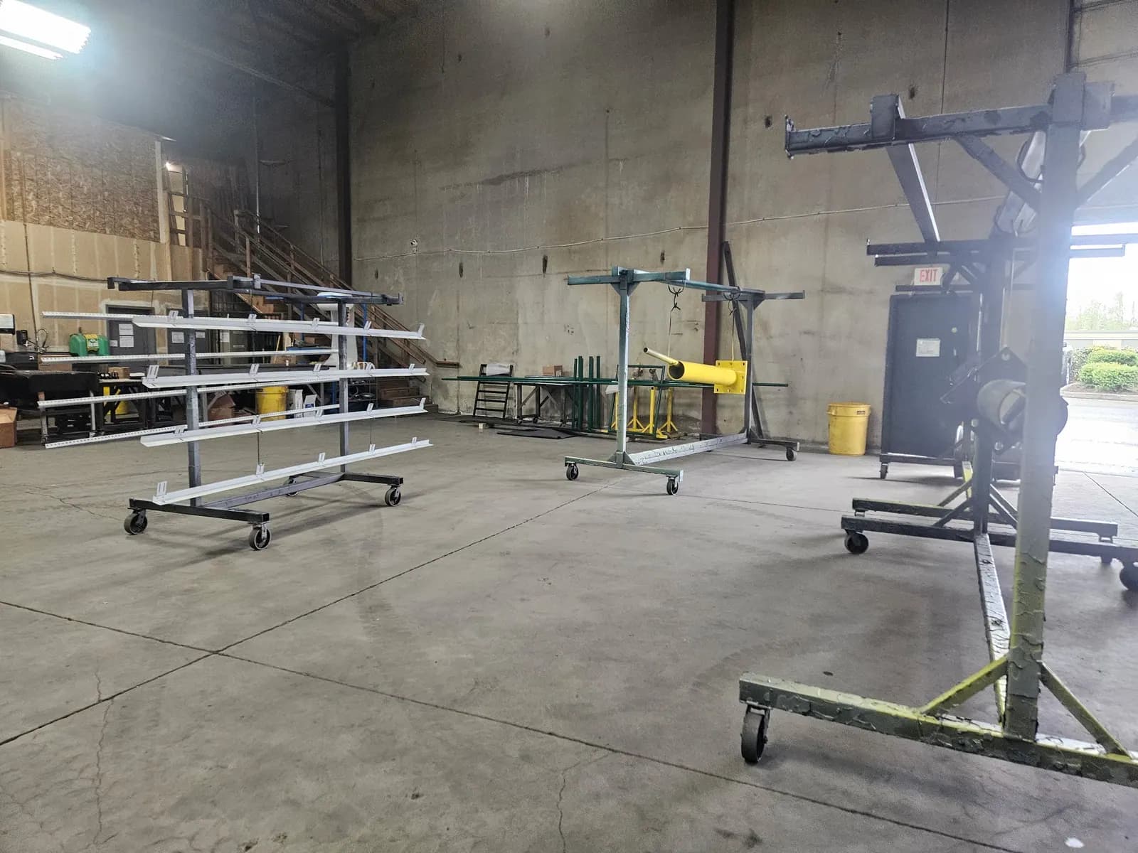 Large wheeled rack used to move long metal pieces through the finishing shop.