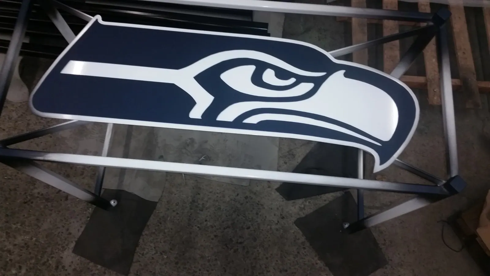 Custom metal sign with a black and white Seahawks-inspired finish.